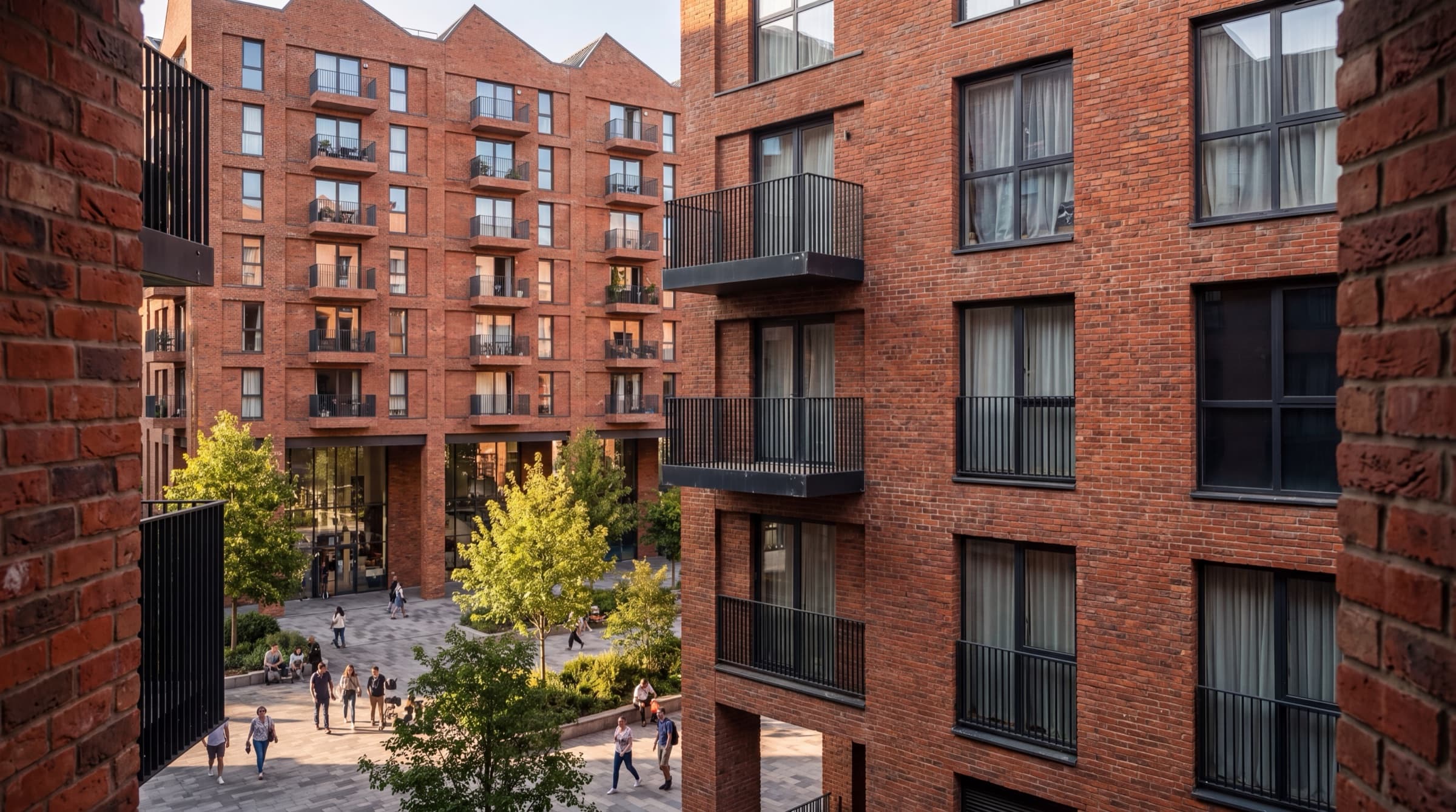 Brick-fronted apartments around a planted courtyard